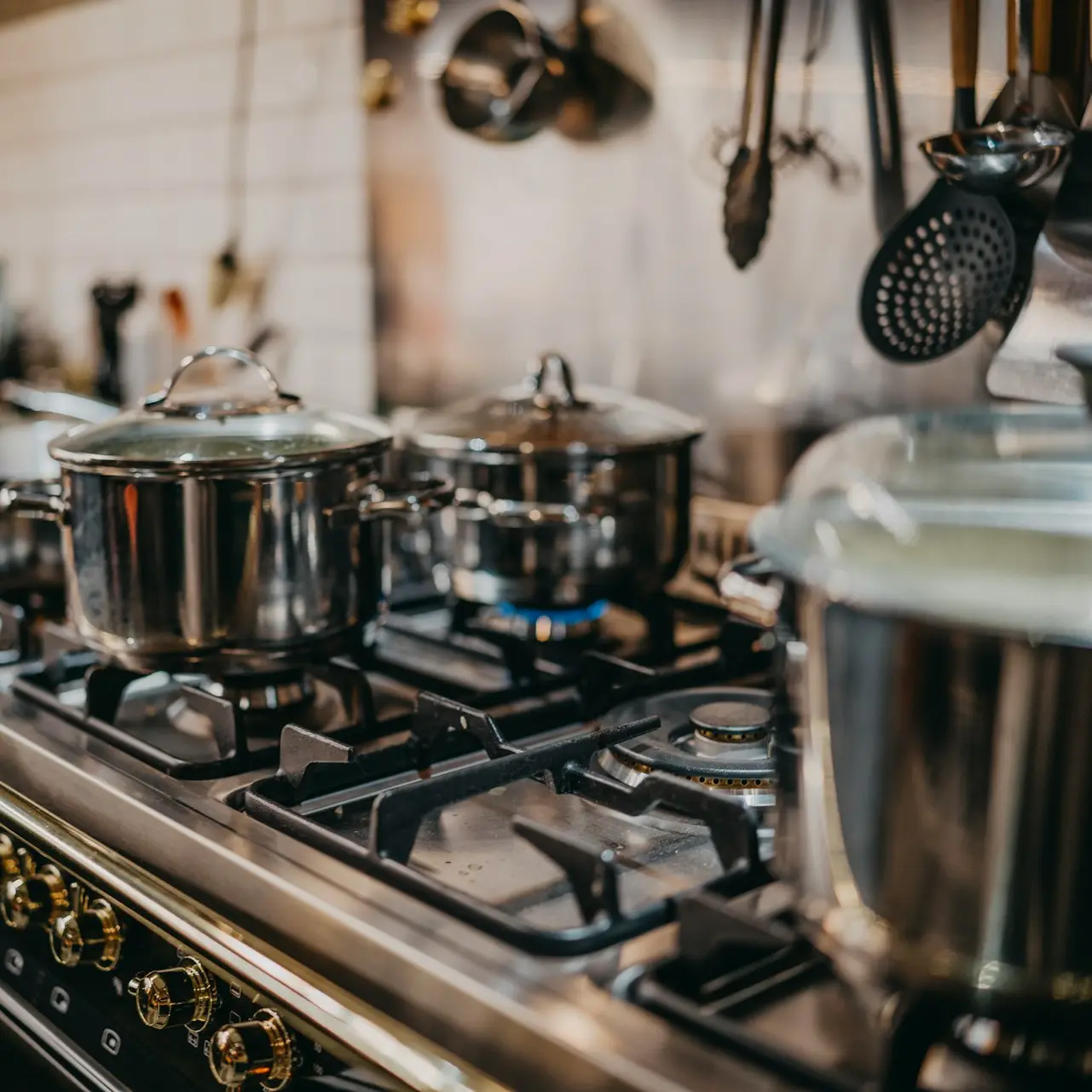 stainless steel cooking pots on gas stove